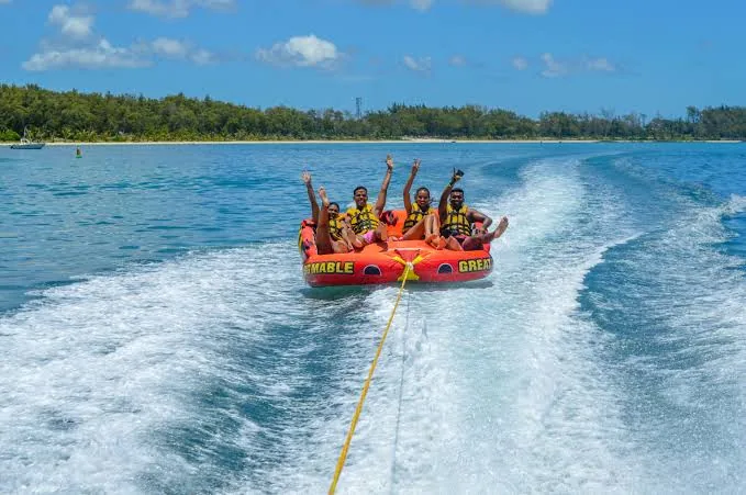 Group enjoying a tube ride across a calm lagoon